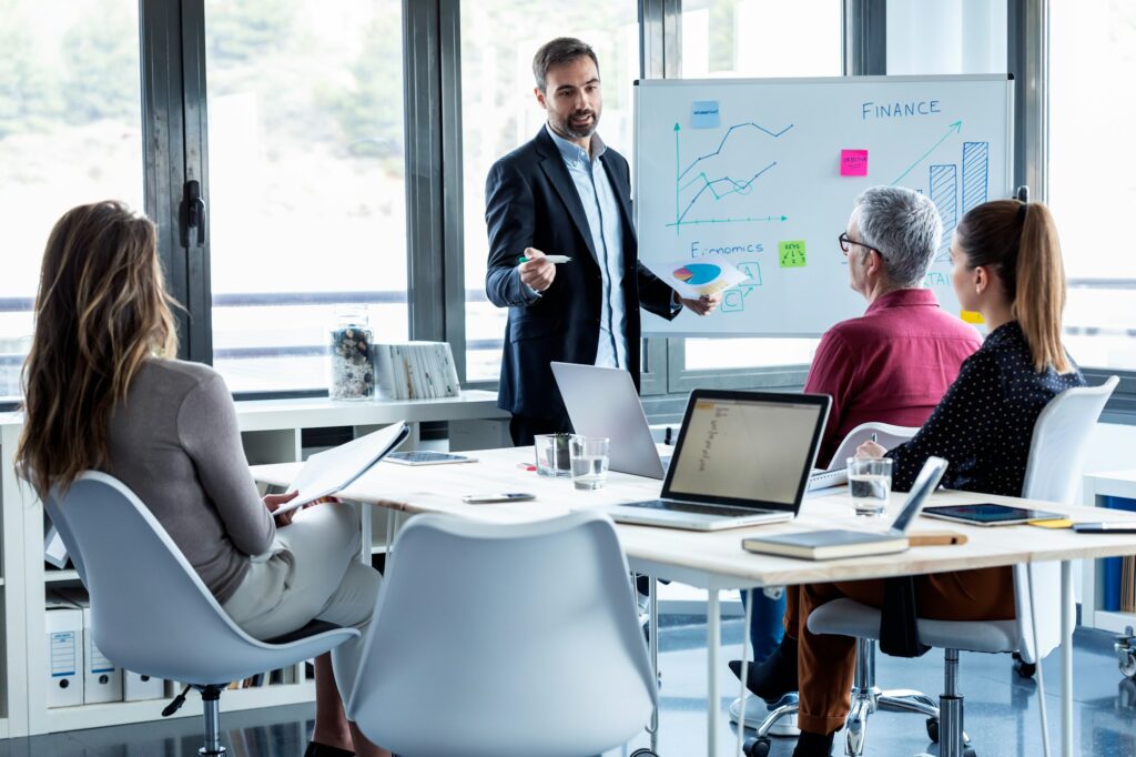 Handsome businessman explaining a project to his colleagues on coworking place.