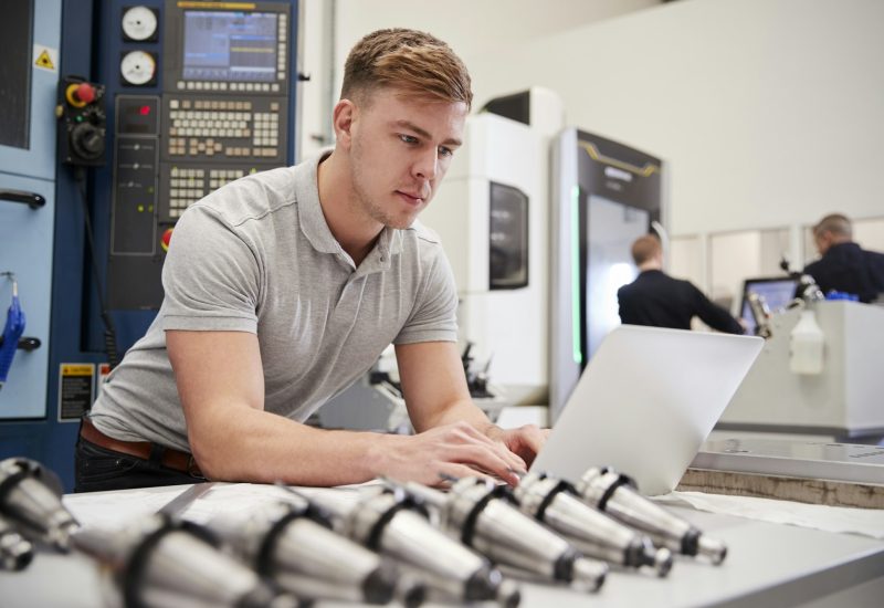 Male Engineer Using CAD Programming Software On Laptop